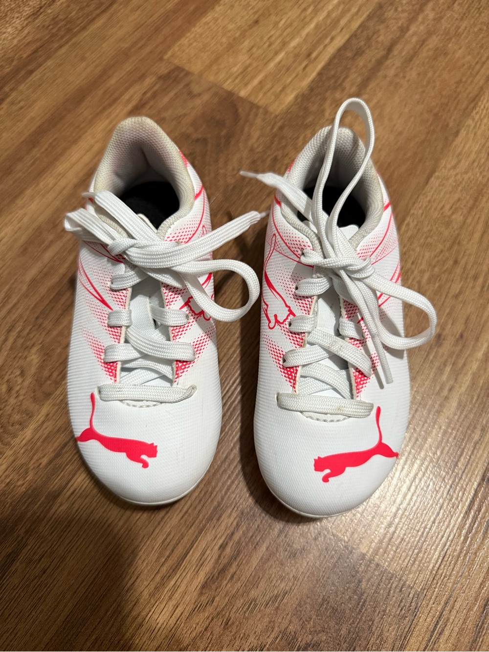 Puma cleats in Bright Pink and white